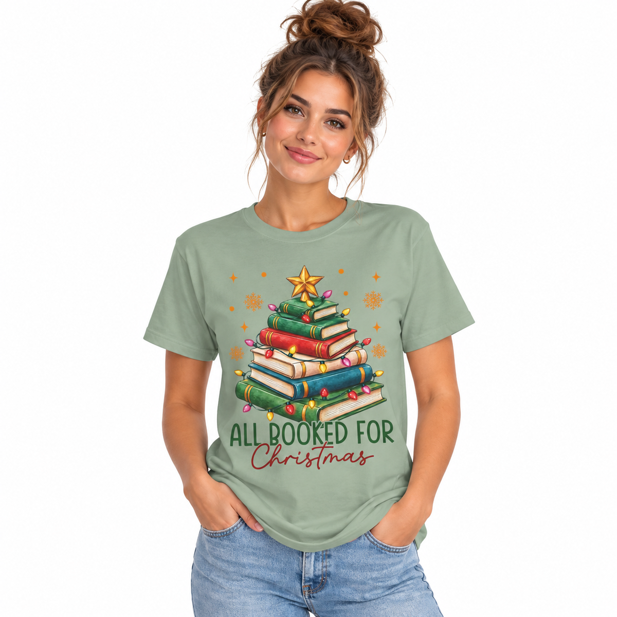 Women's All Booked for Christmas shirt with a Christmas tree made of books in a cozy holiday setting