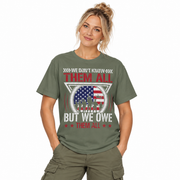 We Don't Know Them All, But We Owe Them All print on a garment-dyed women's shirt