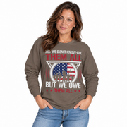 We Don't Know Them All, But We Owe Them All print on a garment-dyed women's long sleeve shirt