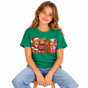 Girl wearing a green Kids Highland Cow Christmas shirt with festive highland cows