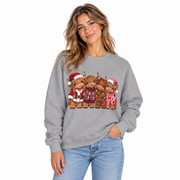 Women's Highland Cow Christmas sweatshirt with festive highland cows