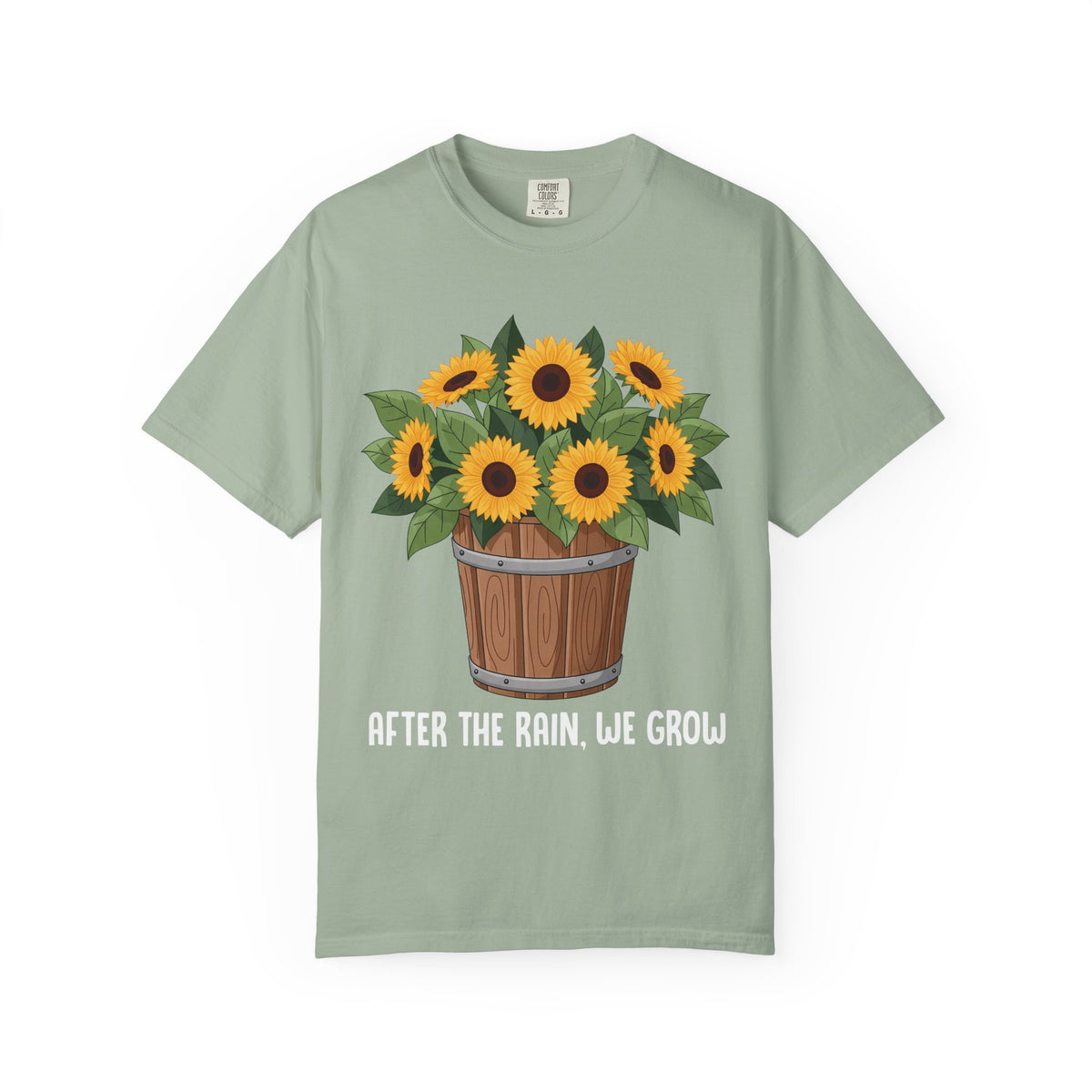 Bucket of sunflowers with After the Rain, We Grow underneath, on a bay green shirt