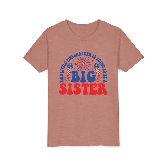 Big sister firecracker announcement with red and blue fireworks, on a heather mauve kids shirt
