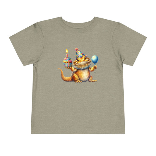 Bearded dragon in a party hat with a cupcake and balloon, on a heather stone toddler shirt