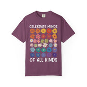 Celebrate Minds of All Kinds above a grid of mismatched flowers, on a berry shirt