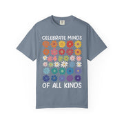 Celebrate Minds of All Kinds above a grid of mismatched flowers, on a blue jean shirt