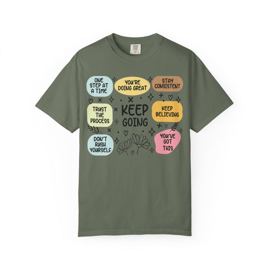 Keep Going affirmation grid printed on a moss green men's shirt