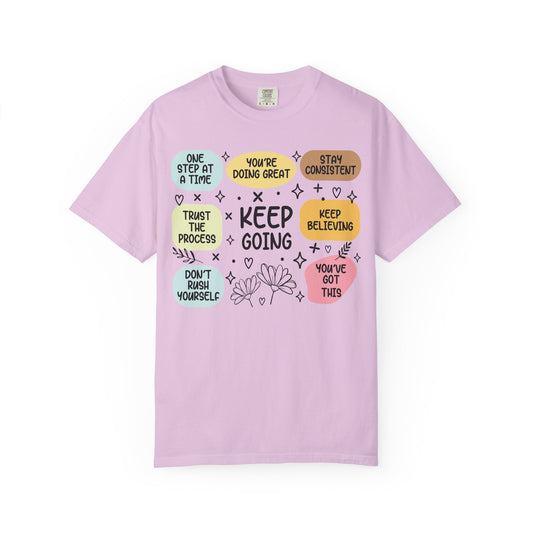 Keep Going affirmations in pastel blocks on an orchid purple women's shirt