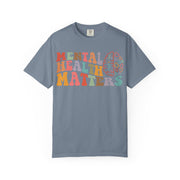 Mental Health Matters in wavy retro type with a brain and hearts, on a blue jean women's shirt