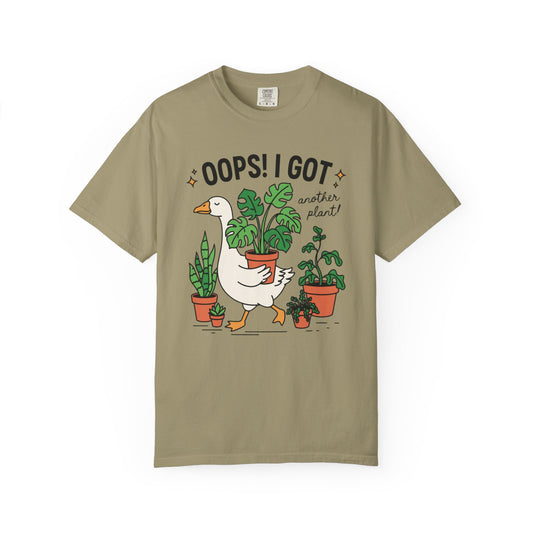 Goose carrying a potted monstera with Oops I Got Another Plant, on a khaki shirt