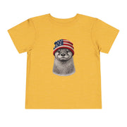 Otter in a USA flag knitted beanie, on a heather yellow gold toddler shirt