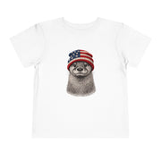 Otter in a USA flag knitted beanie, on a white toddler shirt
