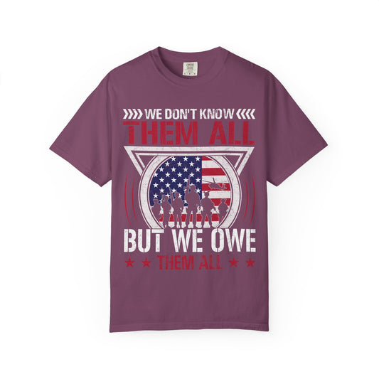 We Don't Know Them All, But We Owe Them All chest print on a berry pink women's shirt