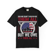 We Don't Know Them All, But We Owe Them All chest print on a black women's shirt