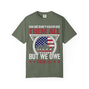 We Don't Know Them All, But We Owe Them All chest print on a moss green women's shirt